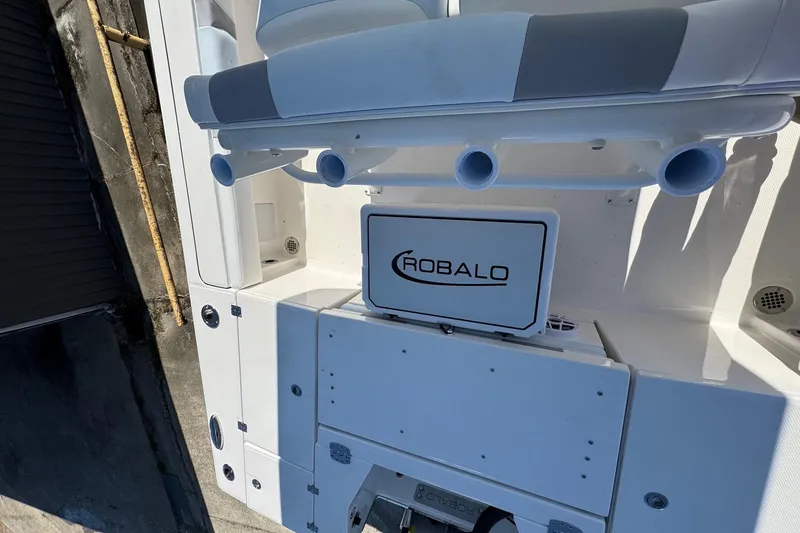 Slide: The Image of 2026 Robalo 246 Cayman boat interior with rod holders and storage compartments. - 20