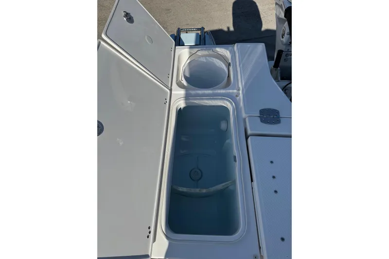 Slide: The Image of Open storage compartments on 2026 Robalo 246 Cayman boat deck. - 21