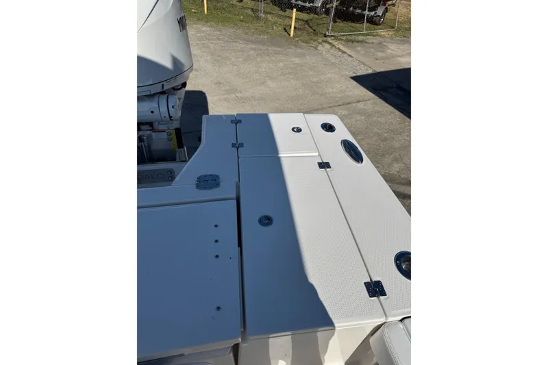Slide: The Image of 2026 Robalo 246 Cayman boat deck with storage compartments and engine view. - 23