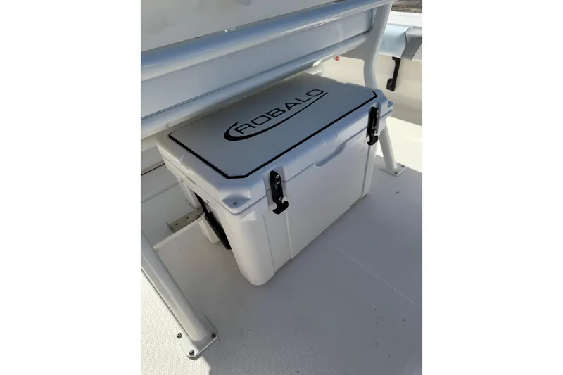 Slide: The Image of Robalo 246 Cayman 2026 boat cooler under seat, white with logo. - 26