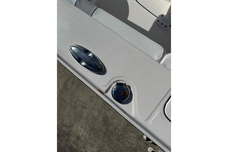 Slide: The Image of 2026 Robalo 246 Cayman boat interior detail with textured surface and chrome handle. - 27