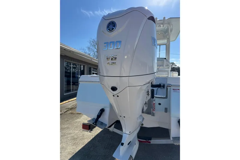 Slide: The Image of 2026 Robalo 246 Cayman with Yamaha 300 V6 outboard engine, parked outdoors. - 3