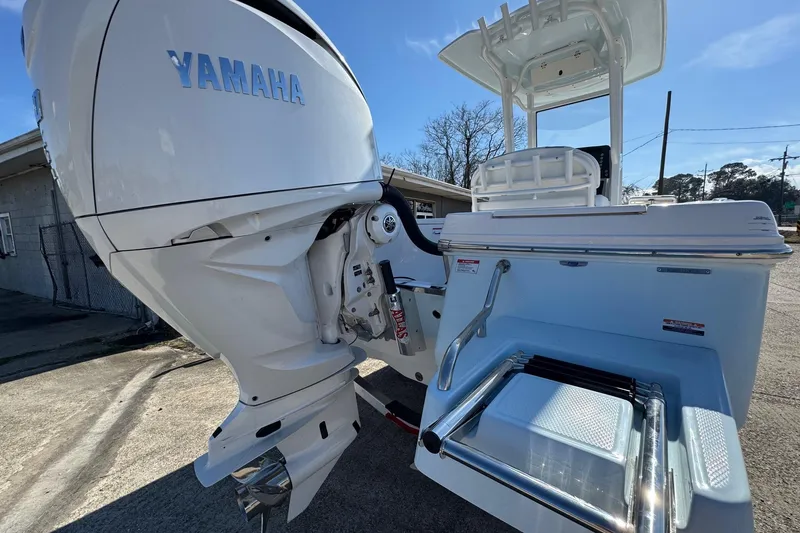 Slide: The Image of 2026 Robalo 246 Cayman boat with Yamaha engine, rear view showing swim platform and ladder. - 4