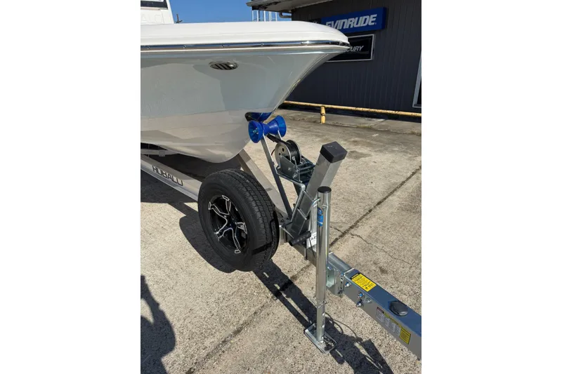 Slide: The Image of 2026 Robalo 246 Cayman boat on trailer, showcasing bow and trailer details. - 6