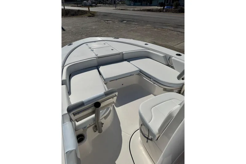 Slide: The Image of 2026 Robalo 246 Cayman boat interior with white seating and storage compartments. - 7