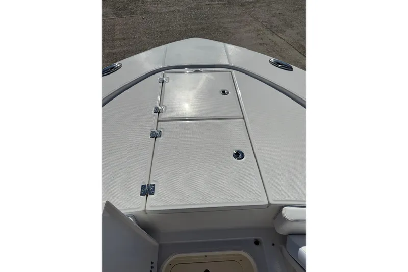 Slide: The Image of Bow deck of 2026 Robalo 246 Cayman boat with storage compartments. - 9