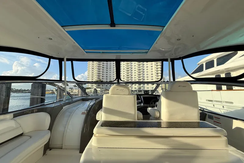 Slide: The Image of Interior view of 2007 Cruisers Yachts 560 Express with blue-tinted roof and luxurious seating. - 12