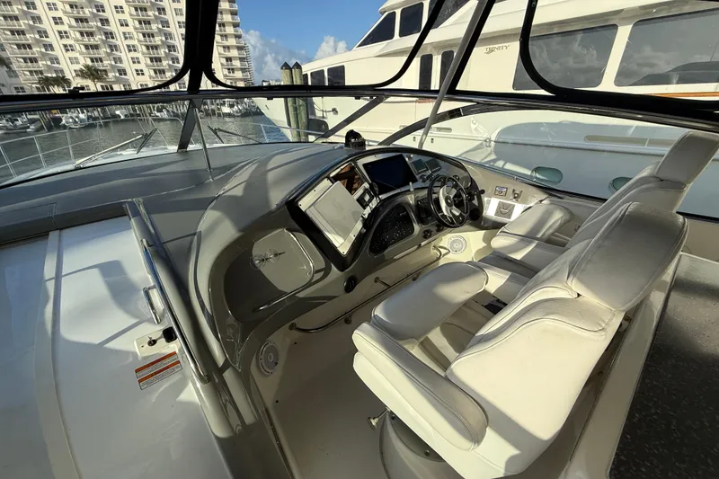 Slide: The Image of 2007 Cruisers Yachts 560 Express helm with modern controls and luxurious seating. - 13