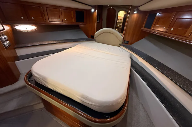 Slide: The Image of Luxurious cabin interior of 2007 Cruisers Yachts 560 Express with elegant wood finishes. - 18