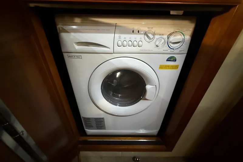 Slide: The Image of Washing machine in 2007 Cruisers Yachts 560 Express, compactly installed in wooden cabinet. - 25