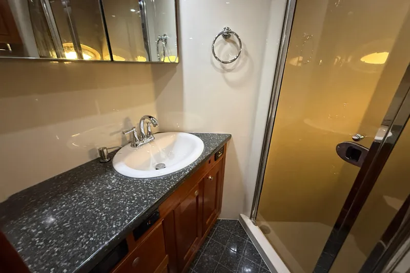 Slide: The Image of Luxurious 2007 Cruisers Yachts 560 Express bathroom with granite countertop and glass shower. - 26