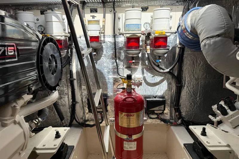 Slide: The Image of Engine room of 2007 Cruisers Yachts 560 Express, featuring filters and fire extinguisher. - 28