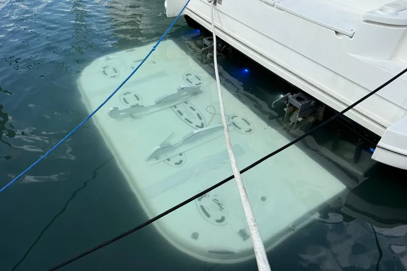 Slide: The Image of 2007 Cruisers Yachts 560 Express with submerged platform in marina. - 4