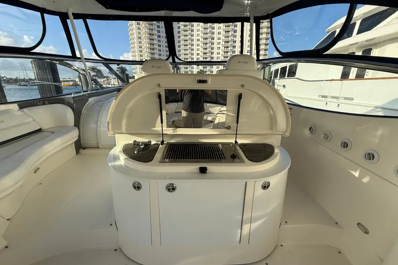 Slide: The Image of 2007 Cruisers Yachts 560 Express interior with grill and seating area. - 9