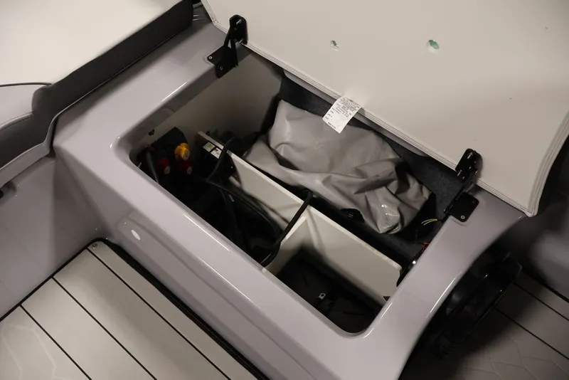 Slide: The Image of Open storage compartment in 2026 Yamaha Boats 252XE, showcasing organized interior space. - 12