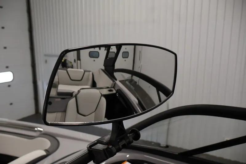 Slide: The Image of Side mirror view of 2026 Yamaha Boats 252XE interior, showcasing sleek seating design. - 28