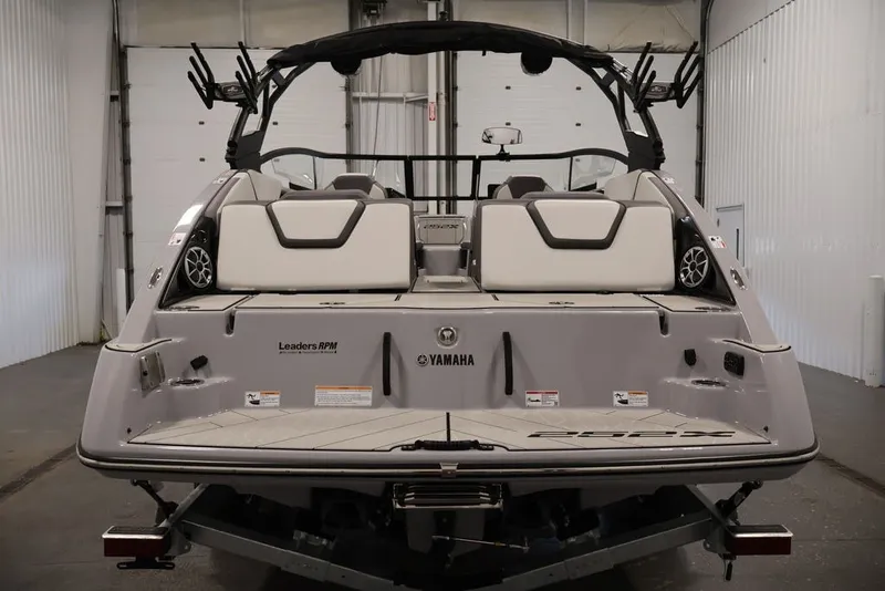 Slide: The Image of 2026 Yamaha Boats 252XE in a showroom, showcasing rear seating and speakers. - 61