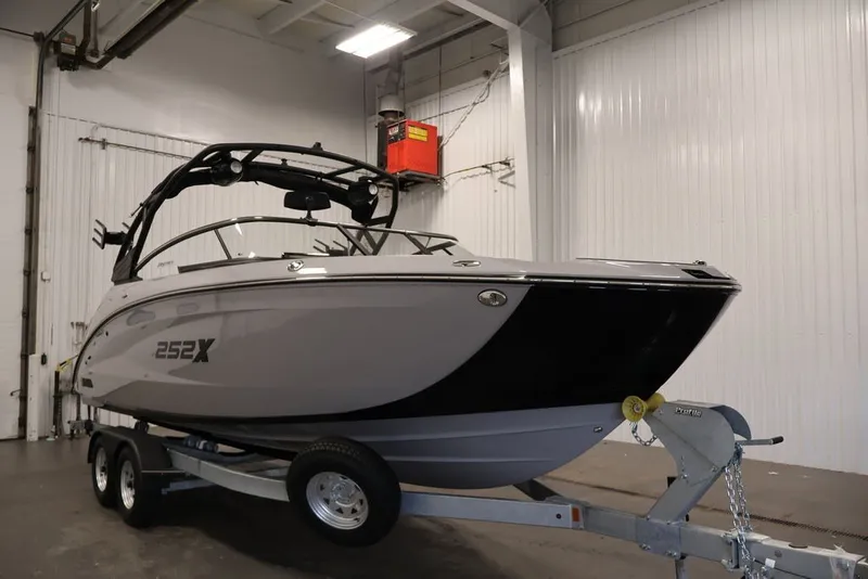 Slide: The Image of 2026 Yamaha Boats 252XE on trailer in indoor storage facility. - 2