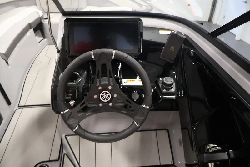 Slide: The Image of 2026 Yamaha Boats 252XE cockpit with steering wheel and modern dashboard controls. - 42