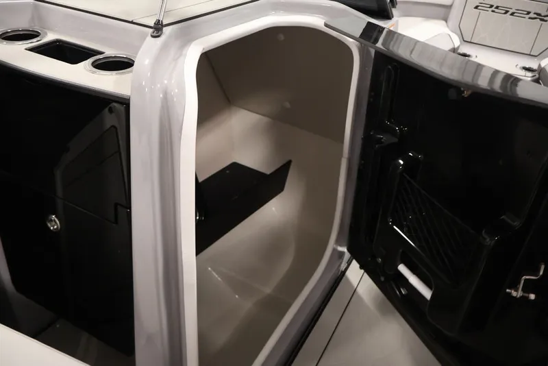 Slide: The Image of Interior view of 2026 Yamaha Boats 252XE, showcasing storage compartment and cup holders. - 24