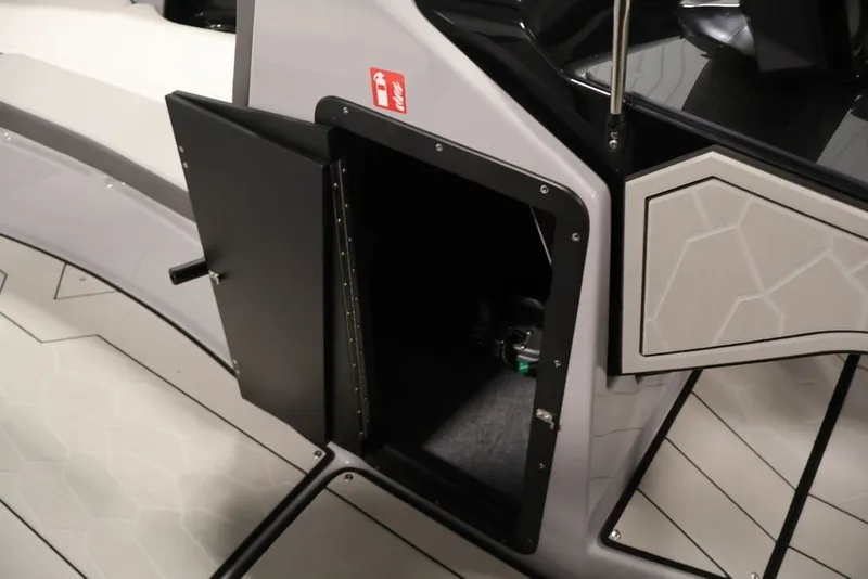 Slide: The Image of Open storage compartment on 2026 Yamaha Boats 252XE, featuring sleek interior design. - 29