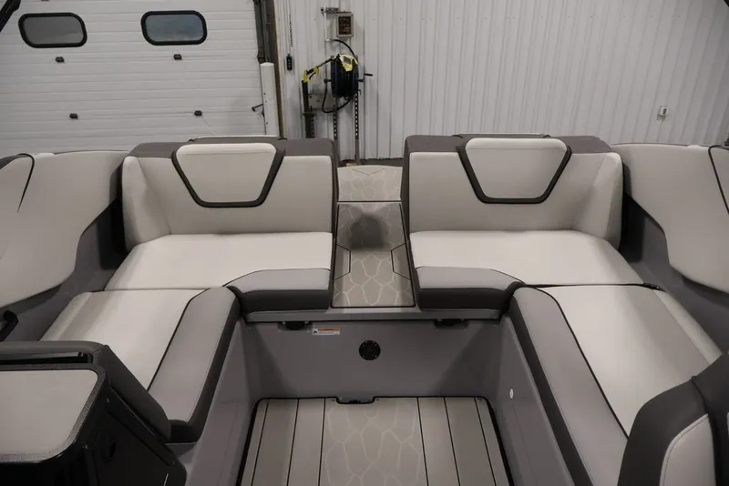 Slide: The Image of 2026 Yamaha Boats 252XE interior with sleek, modern seating in a spacious layout. - 17
