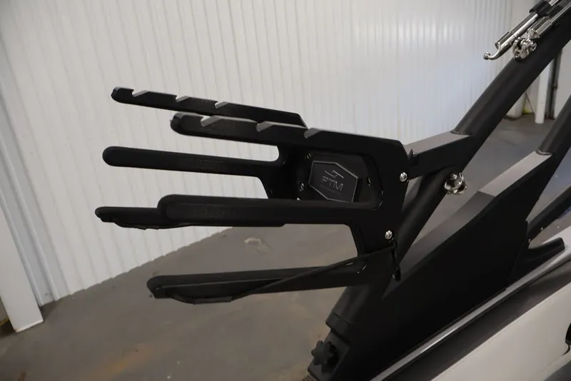 Slide: The Image of Wakeboard rack on 2026 Yamaha Boats 252XE, featuring sleek black design in a garage setting. - 11