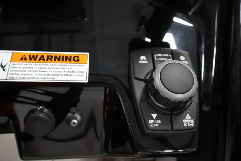 Slide: The Image of Control panel of 2026 Yamaha Boats 252XE with warning label and cruise controls. - 21