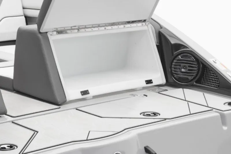 Slide: The Image of Open storage compartment on 2026 Yamaha Boats 252XE with speaker detail. - 43