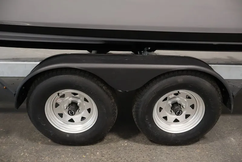 Slide: The Image of Trailer wheels of a 2026 Yamaha Boats 252XE, showcasing dual axle design. - 56