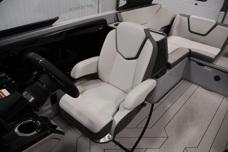 Slide: The Image of 2026 Yamaha Boats 252XE interior with sleek white seating and modern steering wheel design. - 18