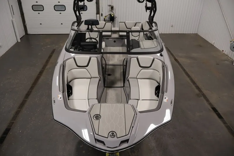 Slide: The Image of 2026 Yamaha Boats 252XE interior, showcasing sleek seating and modern design in a showroom. - 41