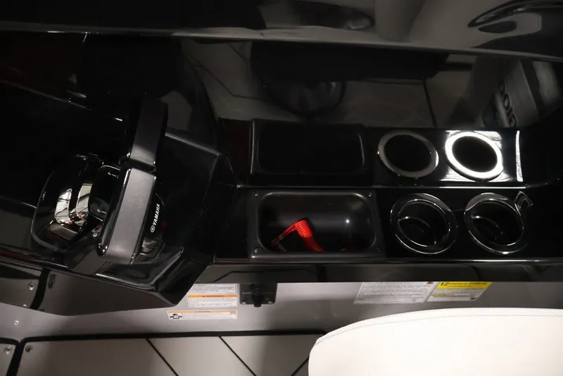 Slide: The Image of 2026 Yamaha Boats 252XE dashboard with controls and cup holders. - 32