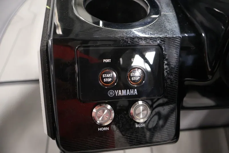 Slide: The Image of Control panel of 2026 Yamaha Boats 252XE with start/stop buttons and horn/bilge controls. - 38