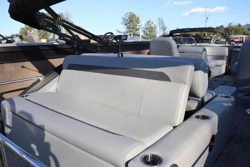 Slide: The Image of 2026 Bentley Pontoons Legacy 223 Swingback interior with luxurious seating and cup holders. - 8