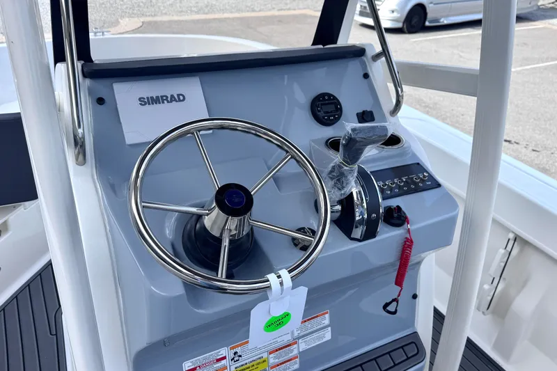Slide: The Image of Steering console of 2026 Trophy CC20 boat with Simrad electronics and control panel. - 11