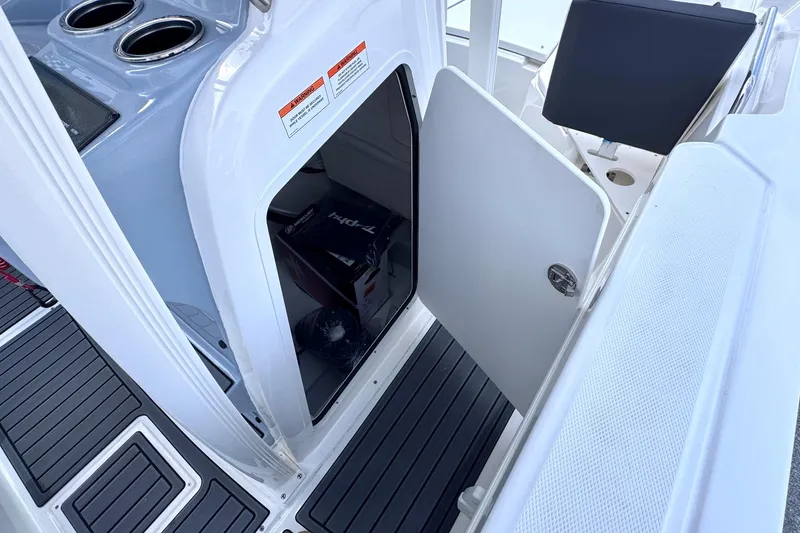 Slide: The Image of Open storage compartment on 2026 Trophy CC20 boat with visible interior items. - 15