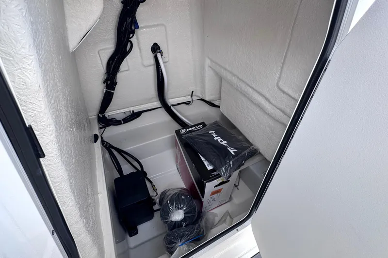 Slide: The Image of Interior storage compartment of 2026 Trophy CC20 boat with wiring and equipment. - 16