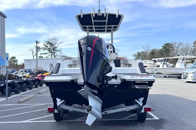 Slide: The Image of 2026 Trophy CC20 boat on trailer, rear view with outboard motor, parked in marina lot. - 5