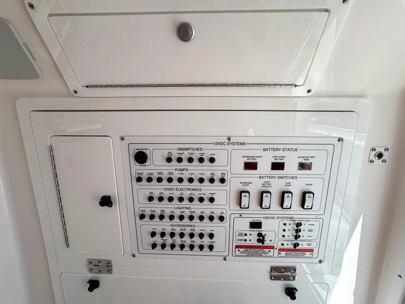 Slide: The Image of Control panel of 2025 Edgewater 325CC boat, featuring switches and battery status indicators. - 13