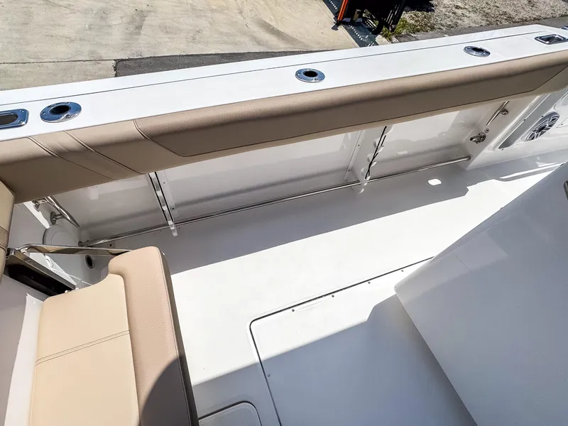Slide: The Image of 2025 Edgewater 325CC boat interior with beige seating and sleek design. - 20