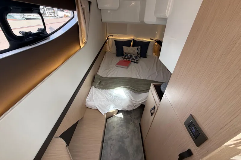 Slide: The Image of Cozy cabin interior of 2026 Jeanneau TH38 with bed, pillows, and window view. - 15