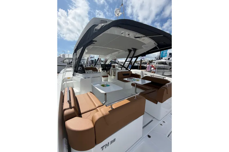 Slide: The Image of 2026 Jeanneau TH38 yacht with spacious seating and modern design under a clear sky. - 8