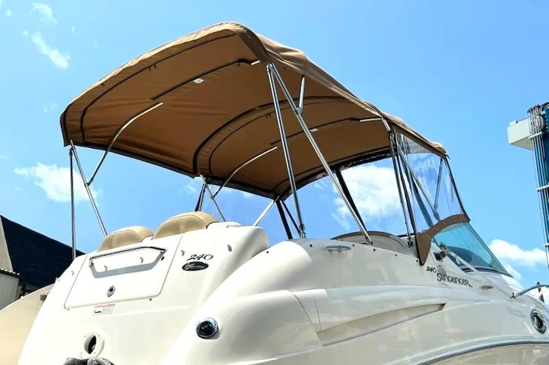Slide: The Image of 2008 Sea Ray 240 Sundancer boat with tan canopy under blue sky. - 3