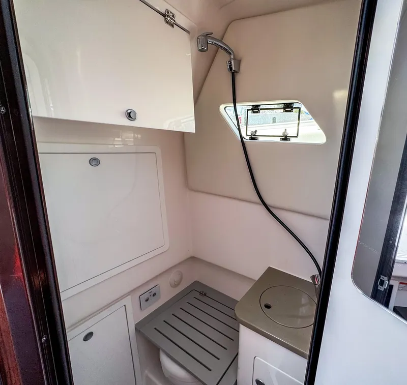 Slide: The Image of Interior of 2025 Edgewater 370CC boat bathroom with shower and window. - 23