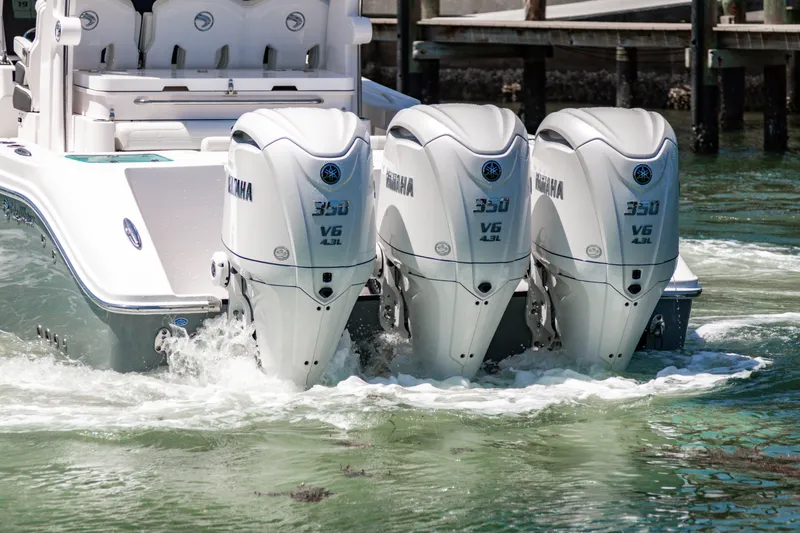 Slide: The Image of 2025 Edgewater 370CC boat with triple Yamaha 300 V6 engines in water. - 8