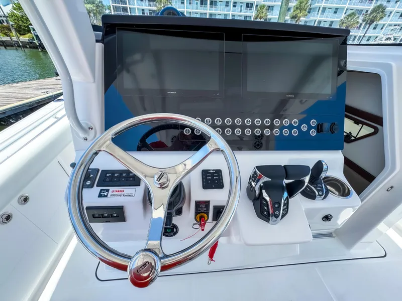 Slide: The Image of 2025 Edgewater 370CC boat helm with modern controls and dual screens. - 16