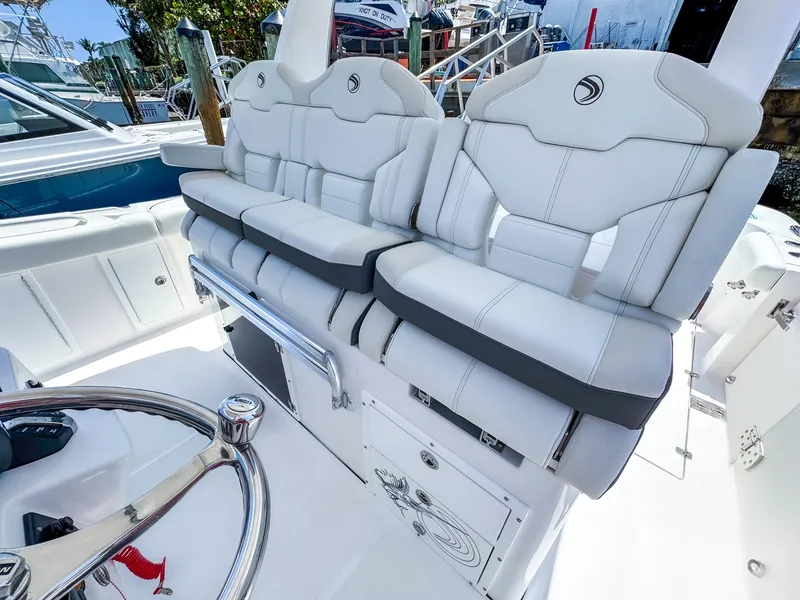 Slide: The Image of 2025 Edgewater 370CC boat with luxurious white seating and sleek design. - 17