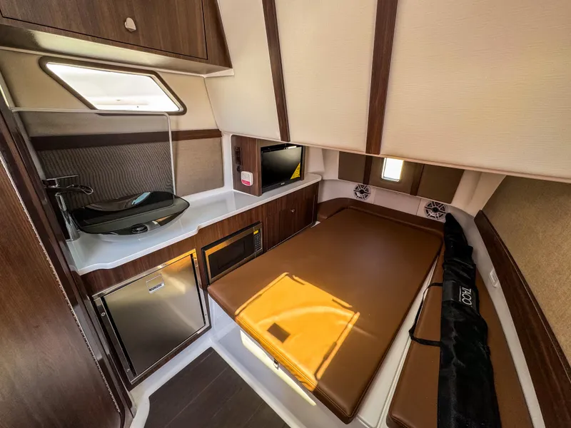 Slide: The Image of 2025 Edgewater 370CC cabin interior with kitchenette, bed, and modern amenities. - 25