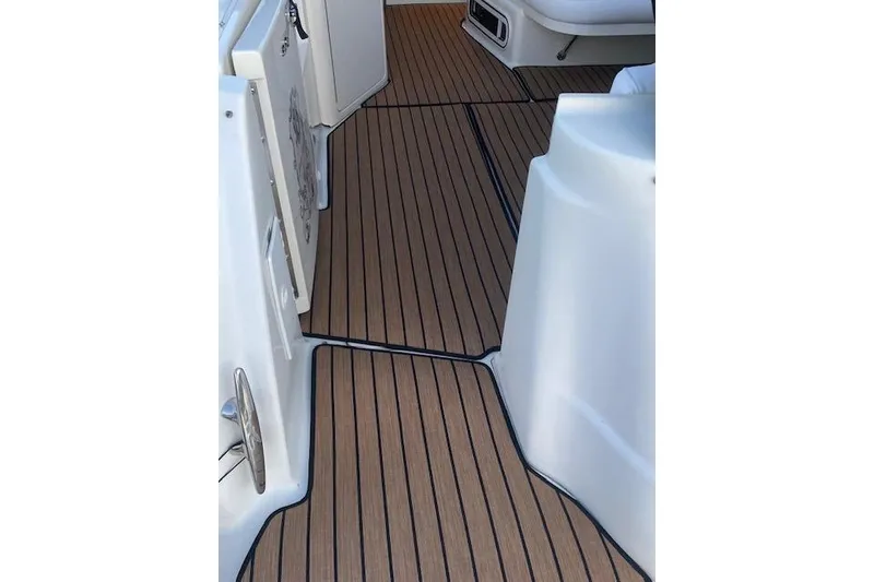Slide: The Image of 2001 Sea Ray 380 Sundancer boat deck with wood-like flooring. - 15